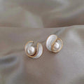 Luxurious earrings featuring white opal and pearl set in gold