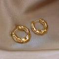 Gold earrings with a textured effect