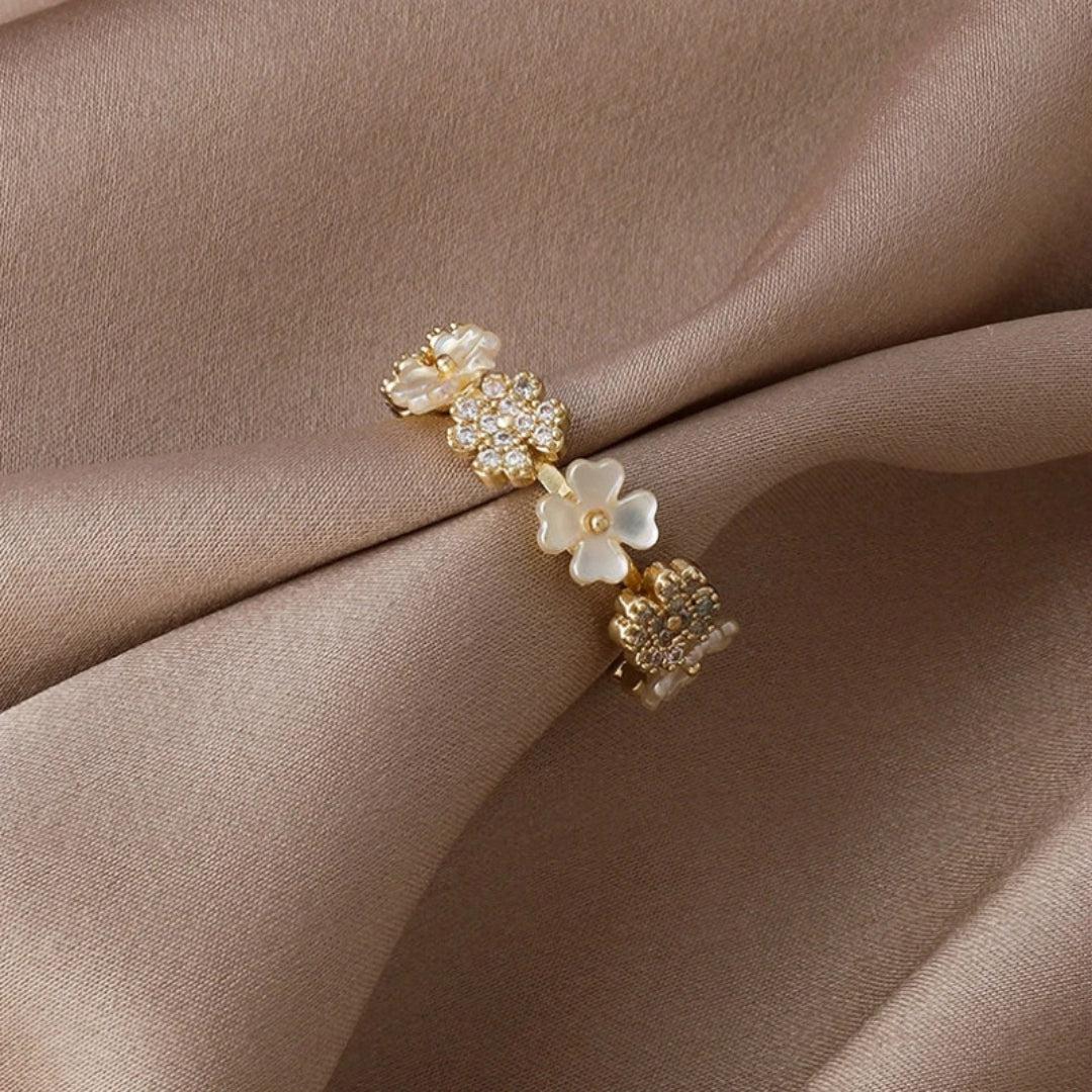 Adjustable gold ring with white blossoms and zirconia