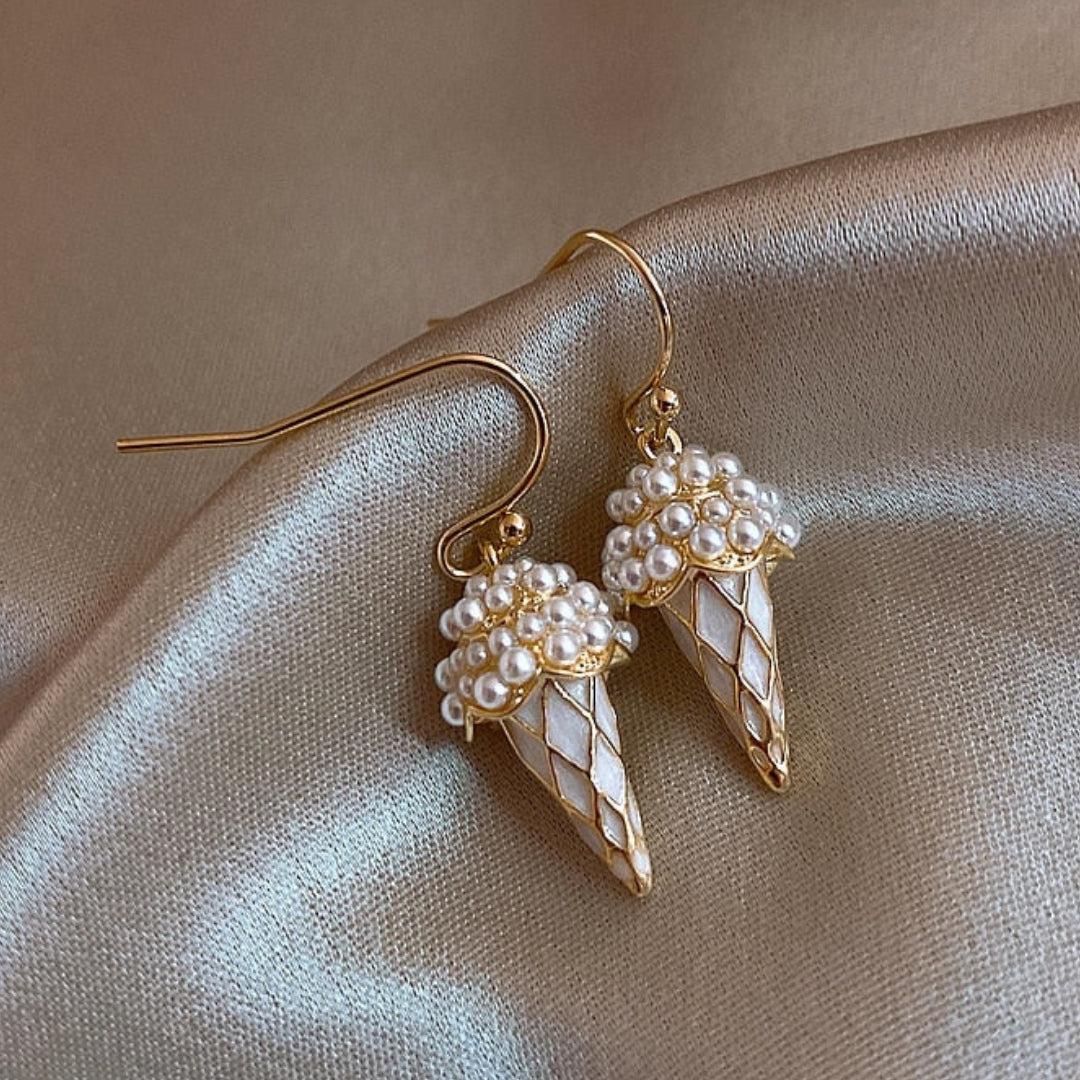 Cone-shaped gold earrings with pearls