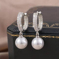 Elegant earrings adorned with lustrous pearls in silver.