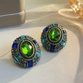 Vintage earrings featuring green crystal and blue cubic zirconia