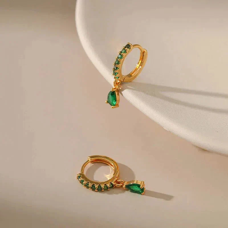 Gold earrings with emerald and zirconia.