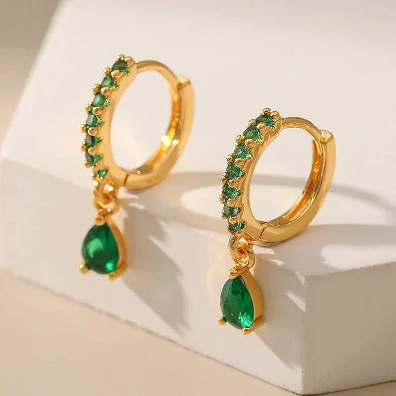 Gold earrings with emerald and zirconia.