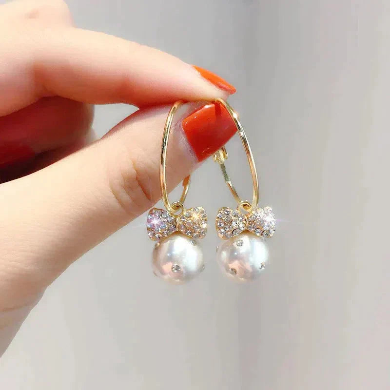 Shiny Gold Earrings Adorned with Pearls