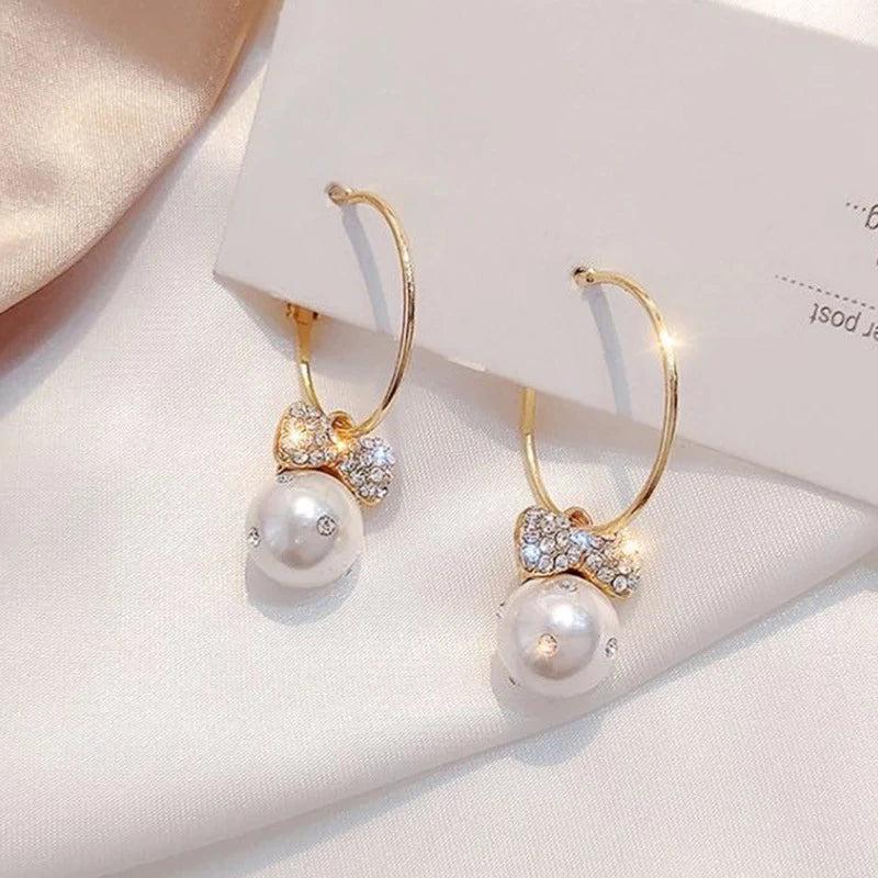 Shiny Gold Earrings Adorned with Pearls