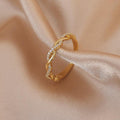 Adjustable ring with braided zirconia stones in gold.