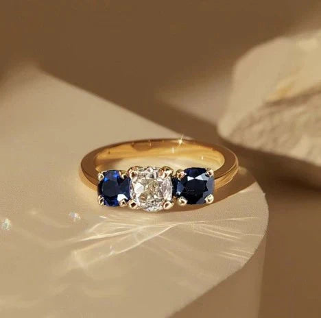 1+1 Offer: Golden Three Stone Cushion Cut White & Blue Sapphire Wedding Band Ring for Women + Round Cut White Sapphire Gold Pendant Necklace