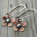 Boho earrings featuring a brown flower crafted from sterling silver.