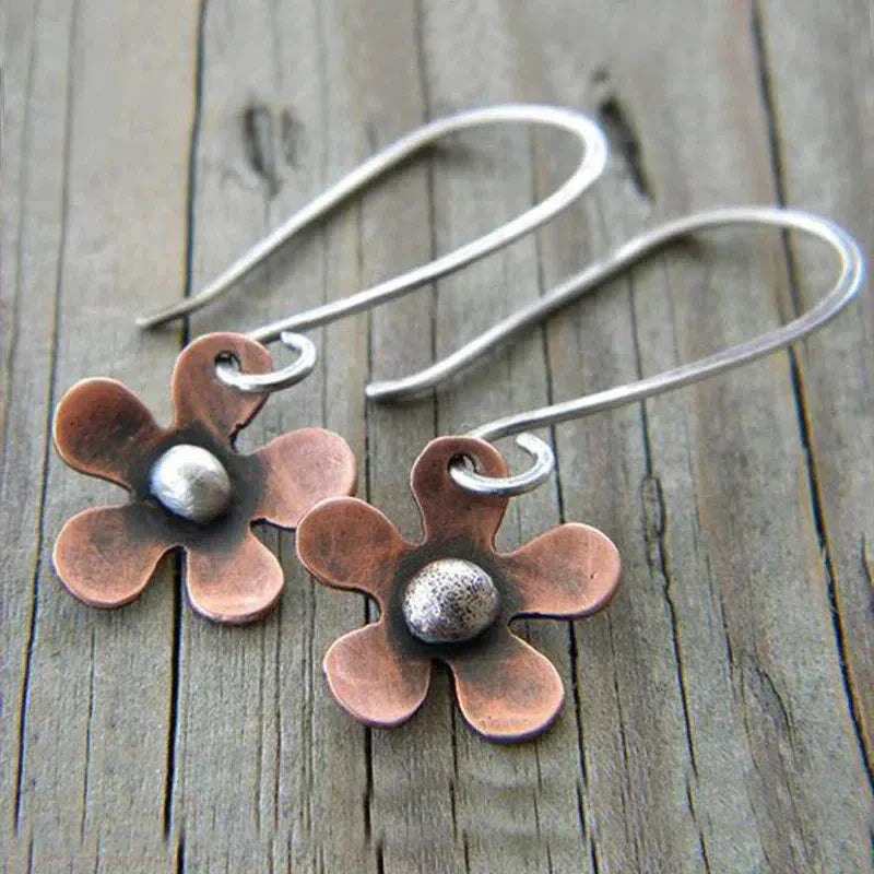 Boho earrings featuring a brown flower crafted from sterling silver.