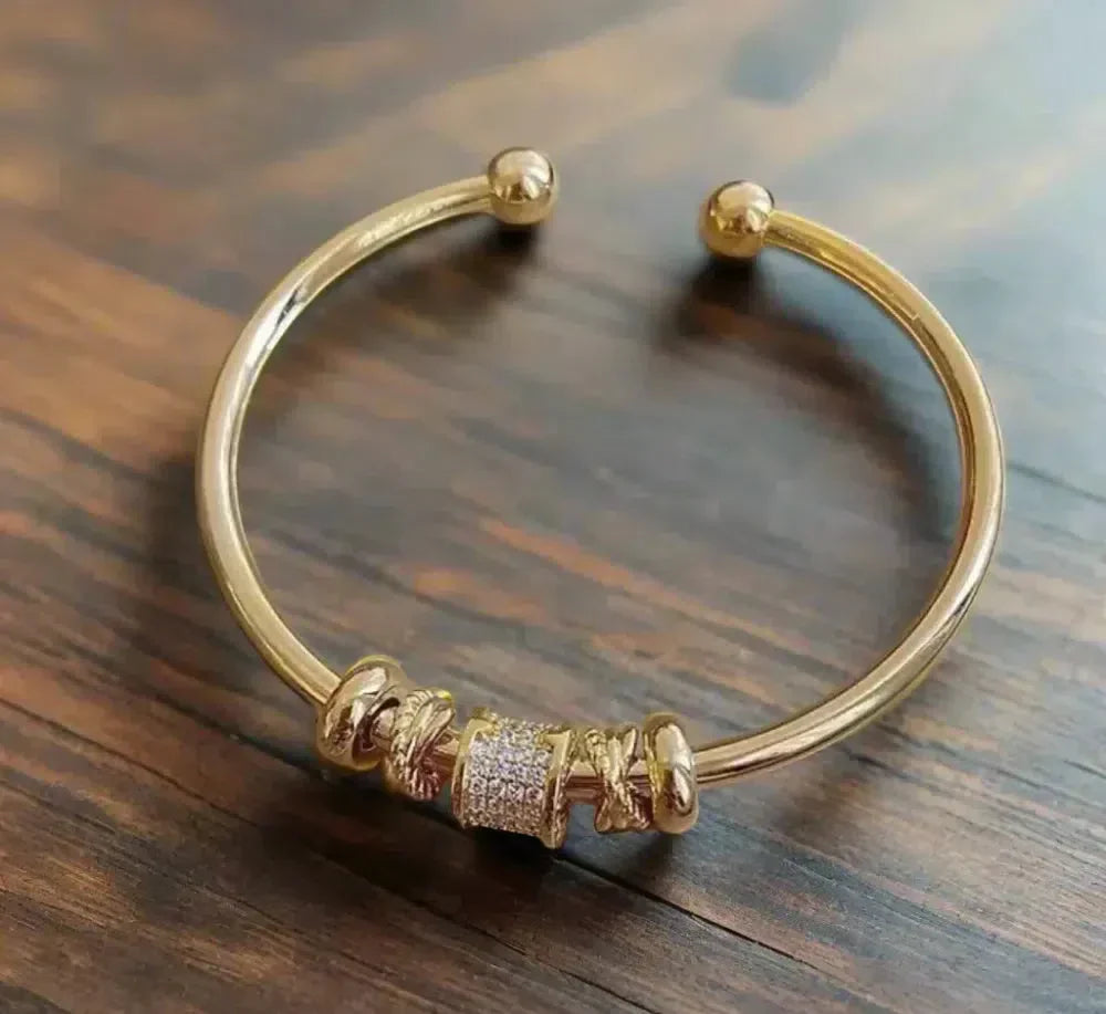 Adjustable wristband with golden charms