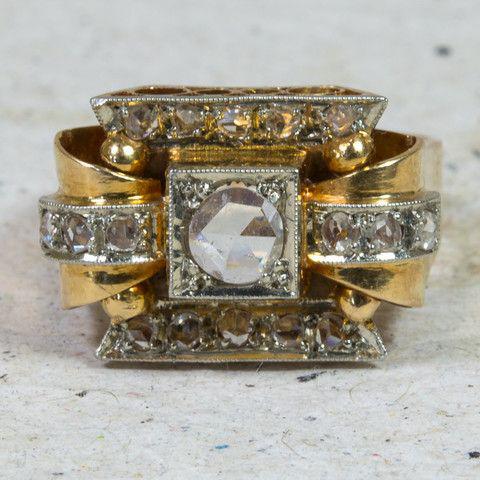 Vintage-style gold ring with a white gemstone.