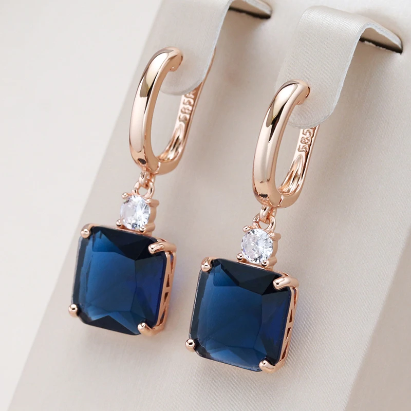 Elegant earrings featuring deep blue crystals set in gold.