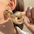 Elegant earrings with a golden ribbon bow