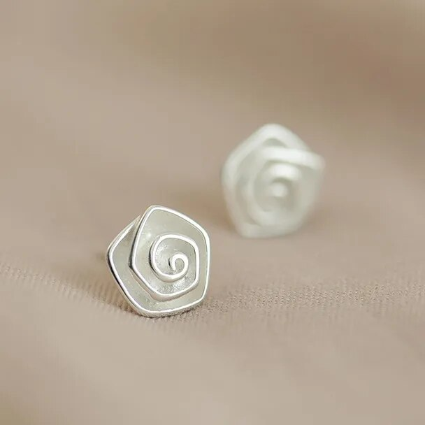 Vintage earrings shaped like a white blossom.