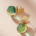 Vintage earrings featuring green crystals set in gold.