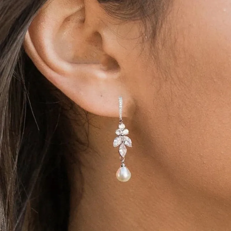 Earrings with dangling pearls on zirconia leaves