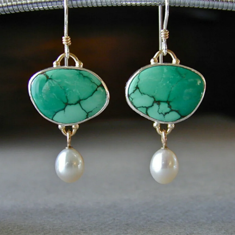 Vintage earrings crafted from turquoise and pearls.