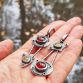 Mechanical earrings crafted from fire crystal