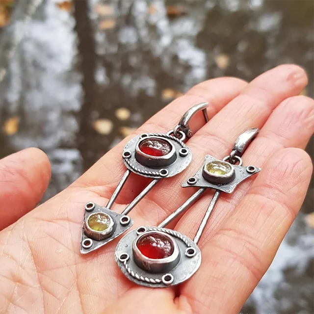 Mechanical earrings crafted from fire crystal