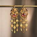 Vintage earrings with a gold and red gemstone pendant