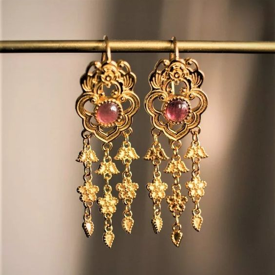Vintage earrings with a gold and red gemstone pendant